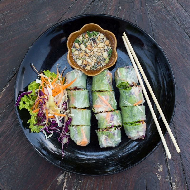 Fresh vietnamese spring rolls on a plate with salad