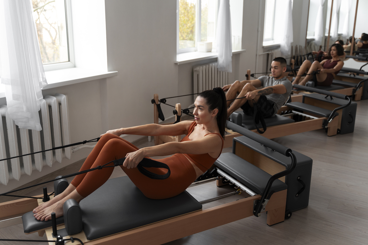 people taking pilates reformer class